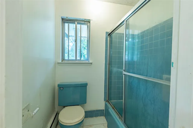 a bathroom with a toilet a sink and shower