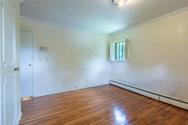 a view of room with wooden floor and window