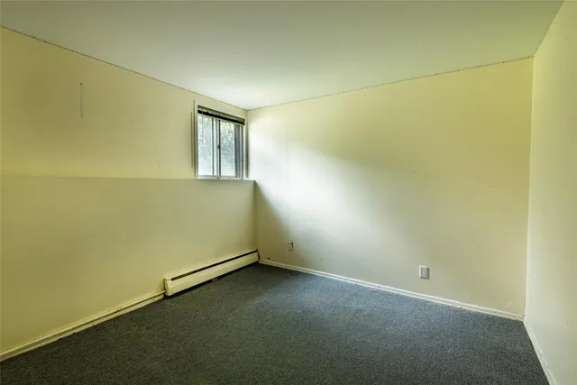 an empty room with a empty space and window