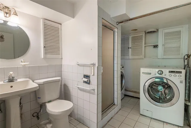 a bathroom with a sink toilet and a mirror