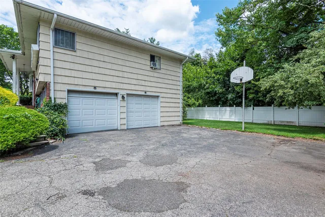 a view of a backyard with plants and brick wall