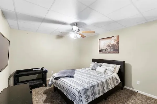 a bedroom with a bed and a chandelier
