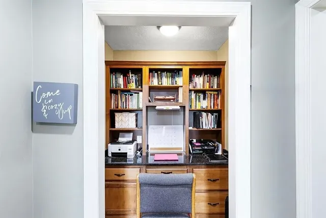 a living room with fish tank and a bookshelf