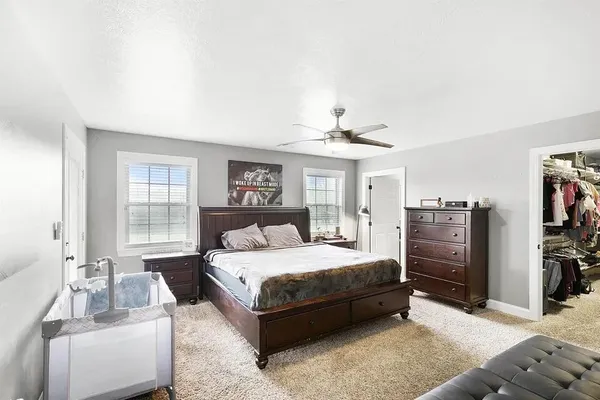 a bedroom with a bed and a couch