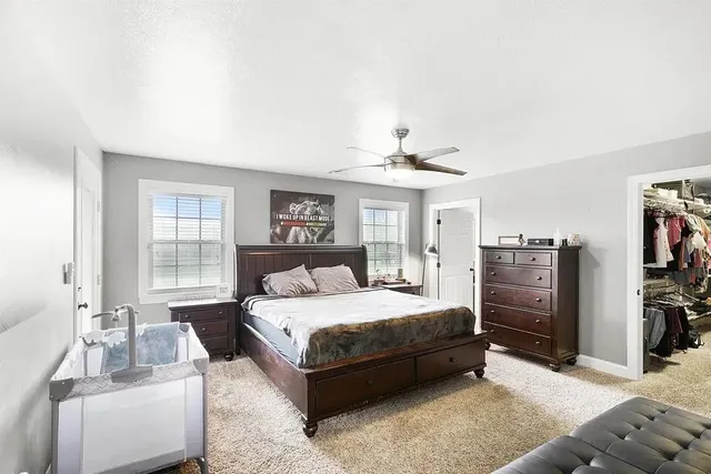 a bedroom with a bed and a couch