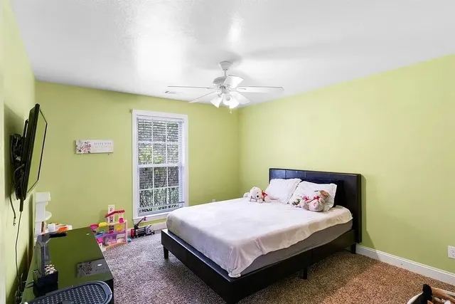 a bedroom with a bed dresser and a window