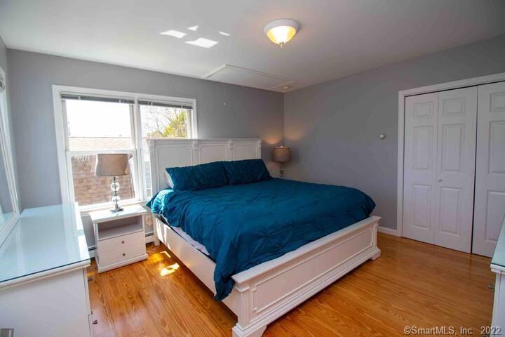10 Grove Way, Unit 10 Clinton, CT 06413 - Photo 12 of 21 a bed sitting in a bedroom next to a window