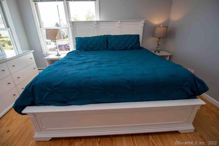 10 Grove Way, Unit 10 Clinton, CT 06413 - Photo 13 of 21 a bed sitting in a bedroom next to a window