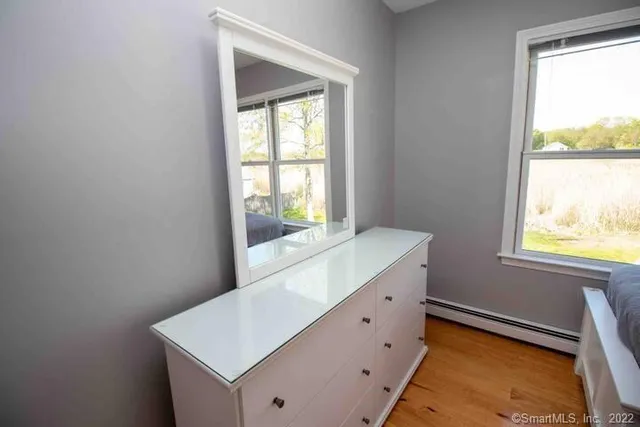 a room with window and bed