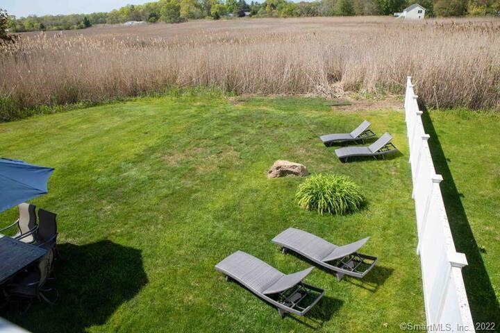 10 Grove Way, Unit 10 Clinton, CT 06413 - Photo 18 of 21 a backyard of a house with lots of green space and lake view