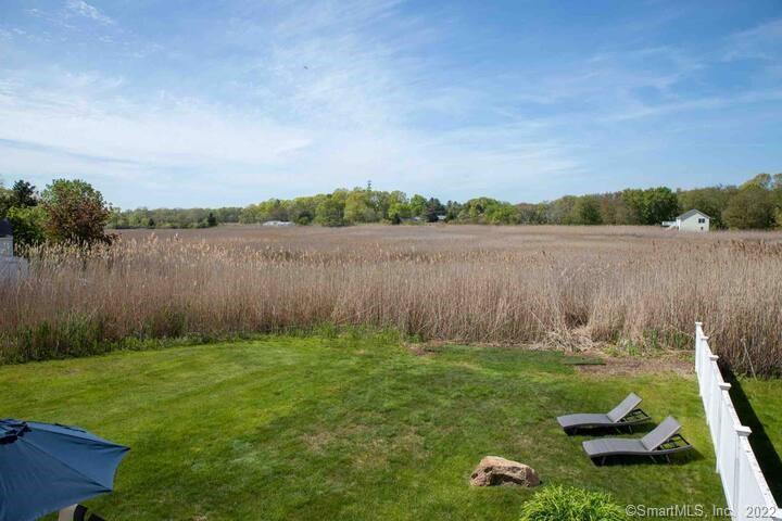 10 Grove Way, Unit 10 Clinton, CT 06413 - Photo 19 of 21 a backyard of a house with lots of green space and lake view