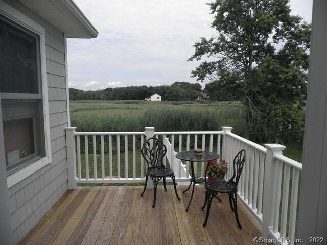 10 Grove Way, Unit 10 Clinton, CT 06413 - Photo 21 of 21 a view of balcony with furniture and hardwood floor