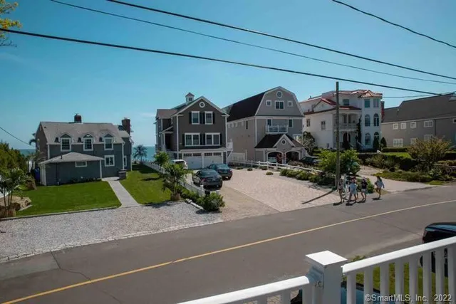 a picture of a building with a garden and pathway