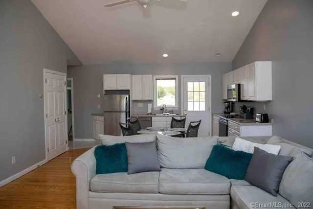 a living room with furniture and a wooden floor