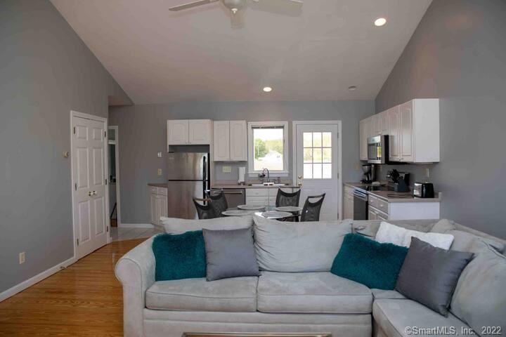10 Grove Way, Unit 10 Clinton, CT 06413 - Photo 7 of 21 a living room with furniture and a wooden floor