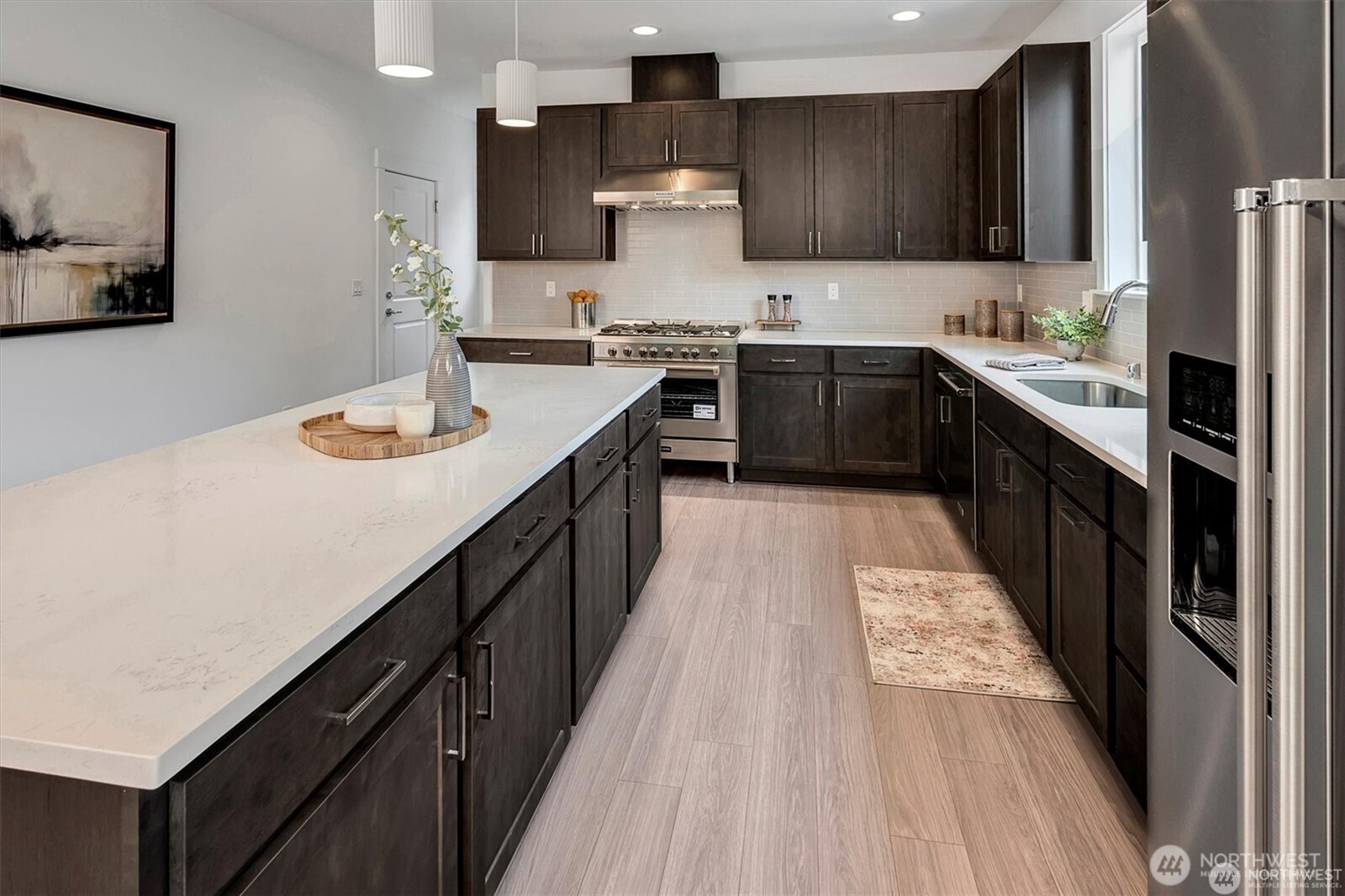 10645 Southeast 170th Pl-lot 11 Renton, WA 98055 - Photo 11 of 29 a kitchen with stainless steel appliances granite countertop sink stove top oven and wooden floor