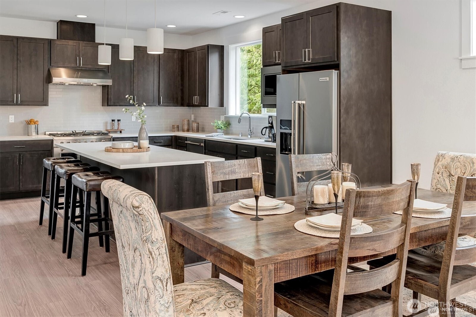 10645 Southeast 170th Pl-lot 11 Renton, WA 98055 - Photo 7 of 29 a kitchen with stainless steel appliances granite countertop a dining table and chairs