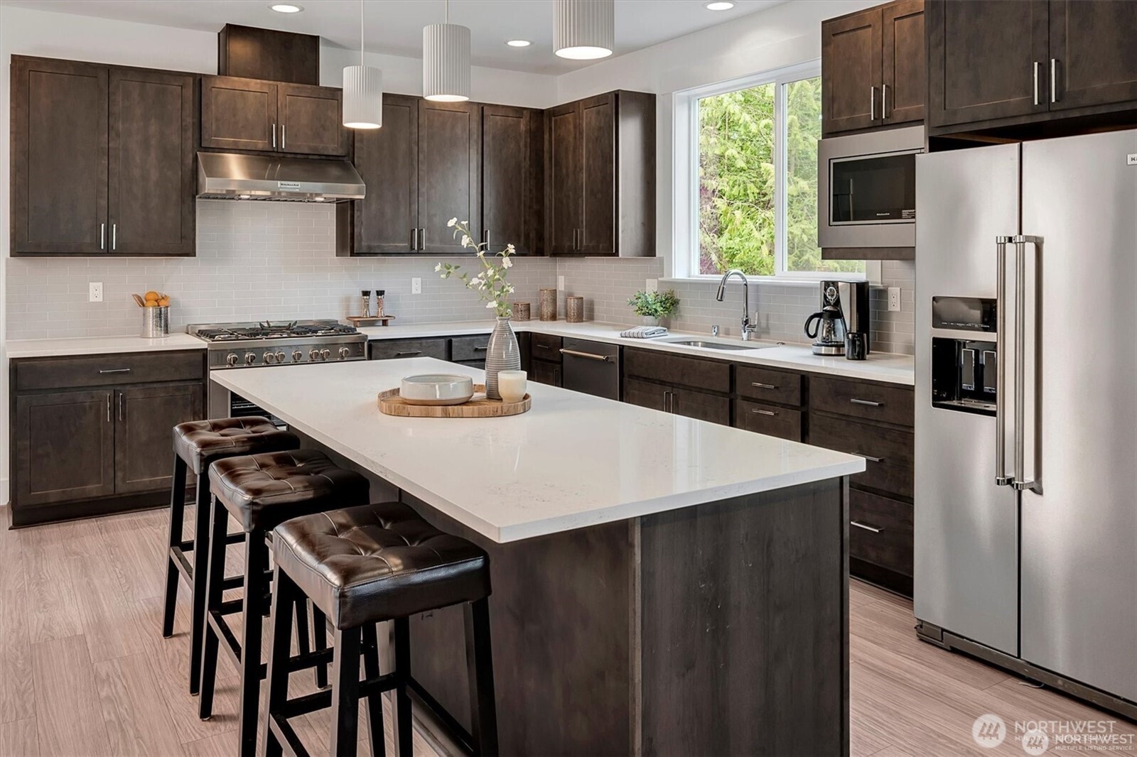 10645 Southeast 170th Pl-lot 11 Renton, WA 98055 - Photo 10 of 29 a kitchen with a sink a stove a refrigerator and cabinets