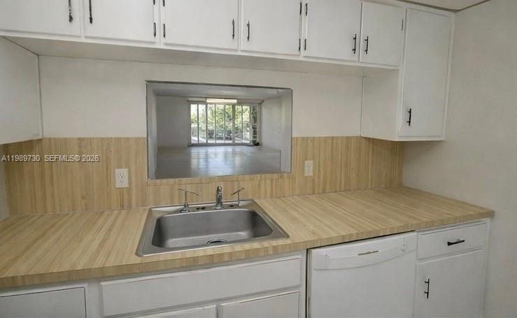 3531 Inverrary Drive, Unit 310 Lauderhill, FL 33319 - Photo 6 of 10 a kitchen with a sink and cabinets