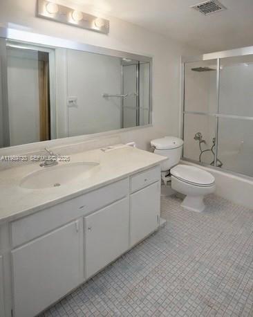 3531 Inverrary Drive, Unit 310 Lauderhill, FL 33319 - Photo 9 of 10 a bathroom with a toilet a sink and mirror