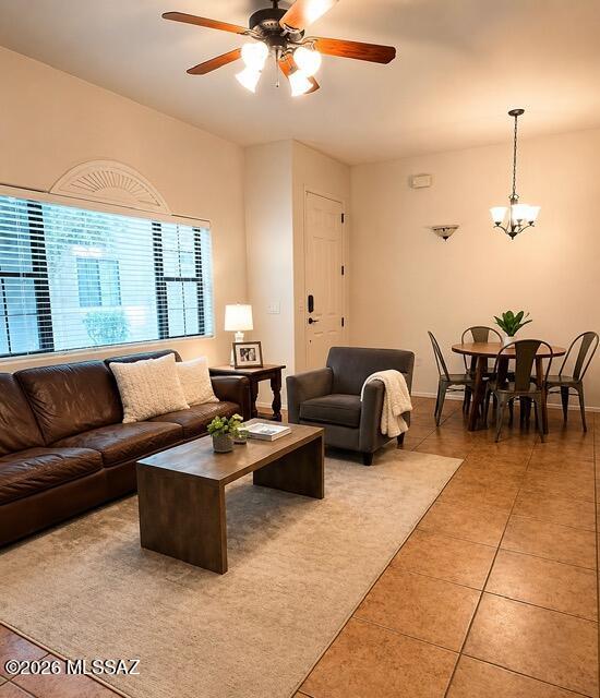2018 East River Road, Unit 102 Tucson, AZ 85718 - Photo 6 of 25 a living room with furniture a ceiling fan and a chandelier