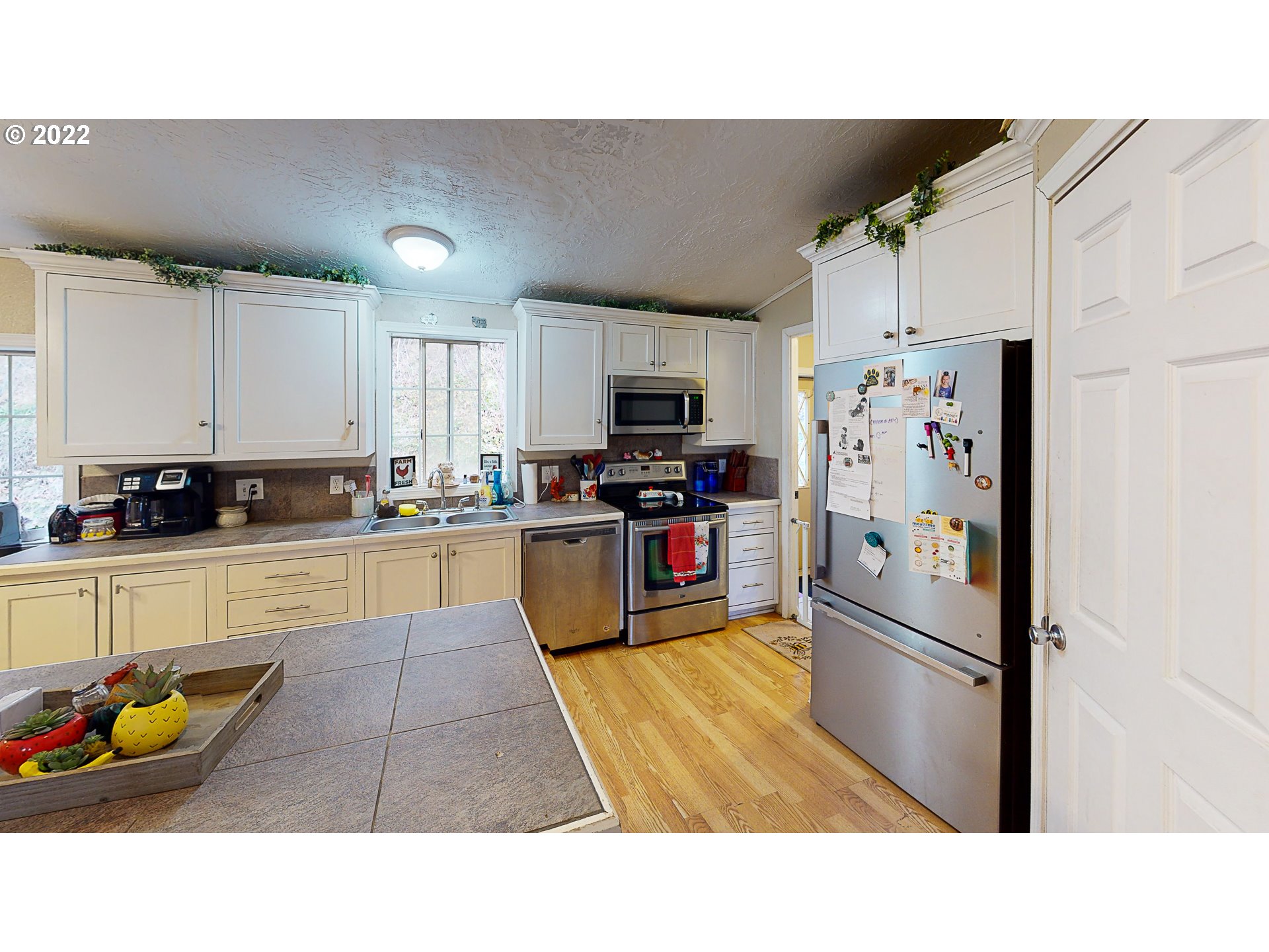 377 P G Sweet Road Kelso, WA 98626 - Photo 14 of 29 a kitchen with stainless steel appliances kitchen island granite countertop a refrigerator and a sink