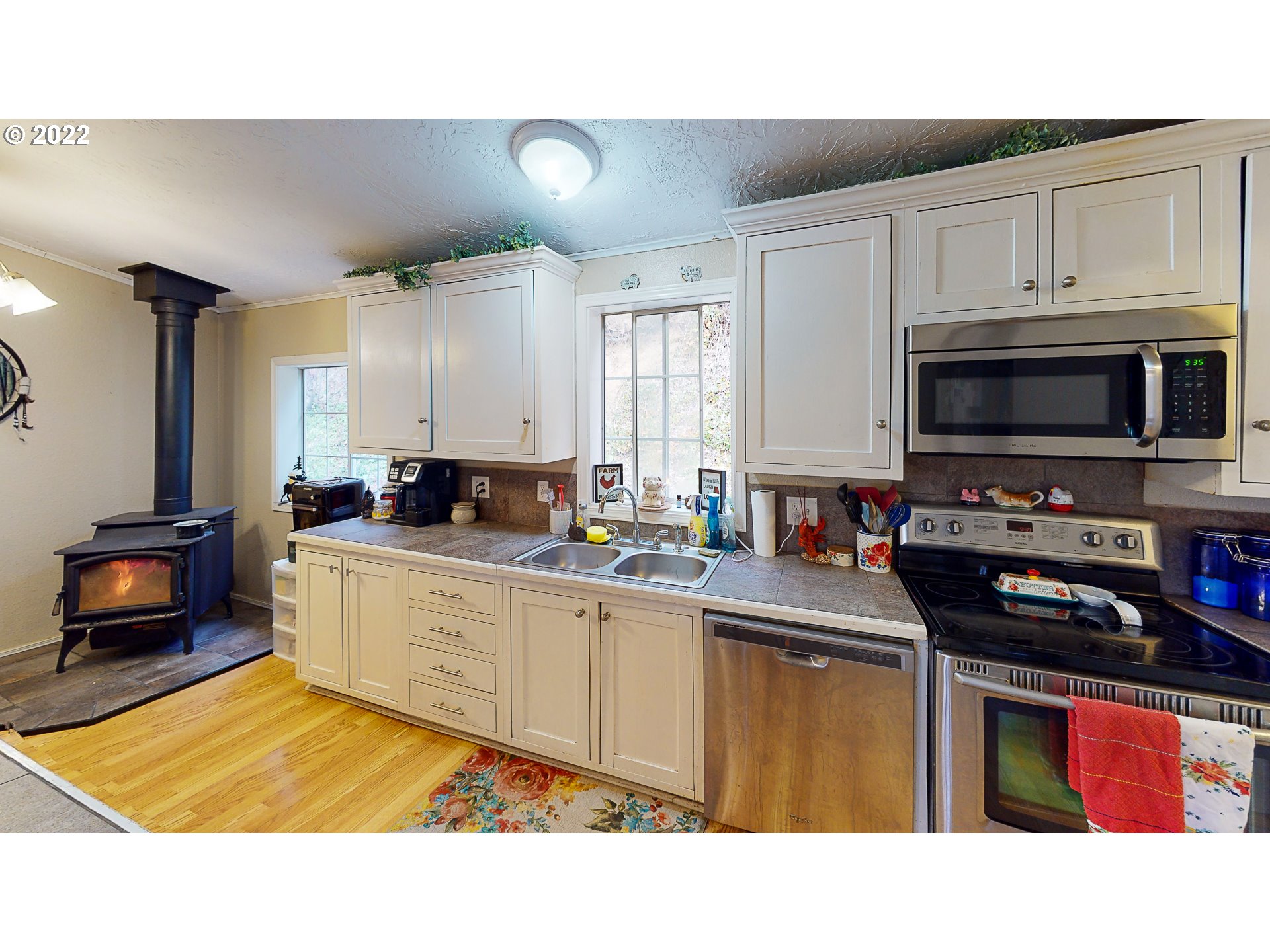 377 P G Sweet Road Kelso, WA 98626 - Photo 15 of 29 a kitchen with stainless steel appliances a sink a stove a refrigerator cabinets and a window