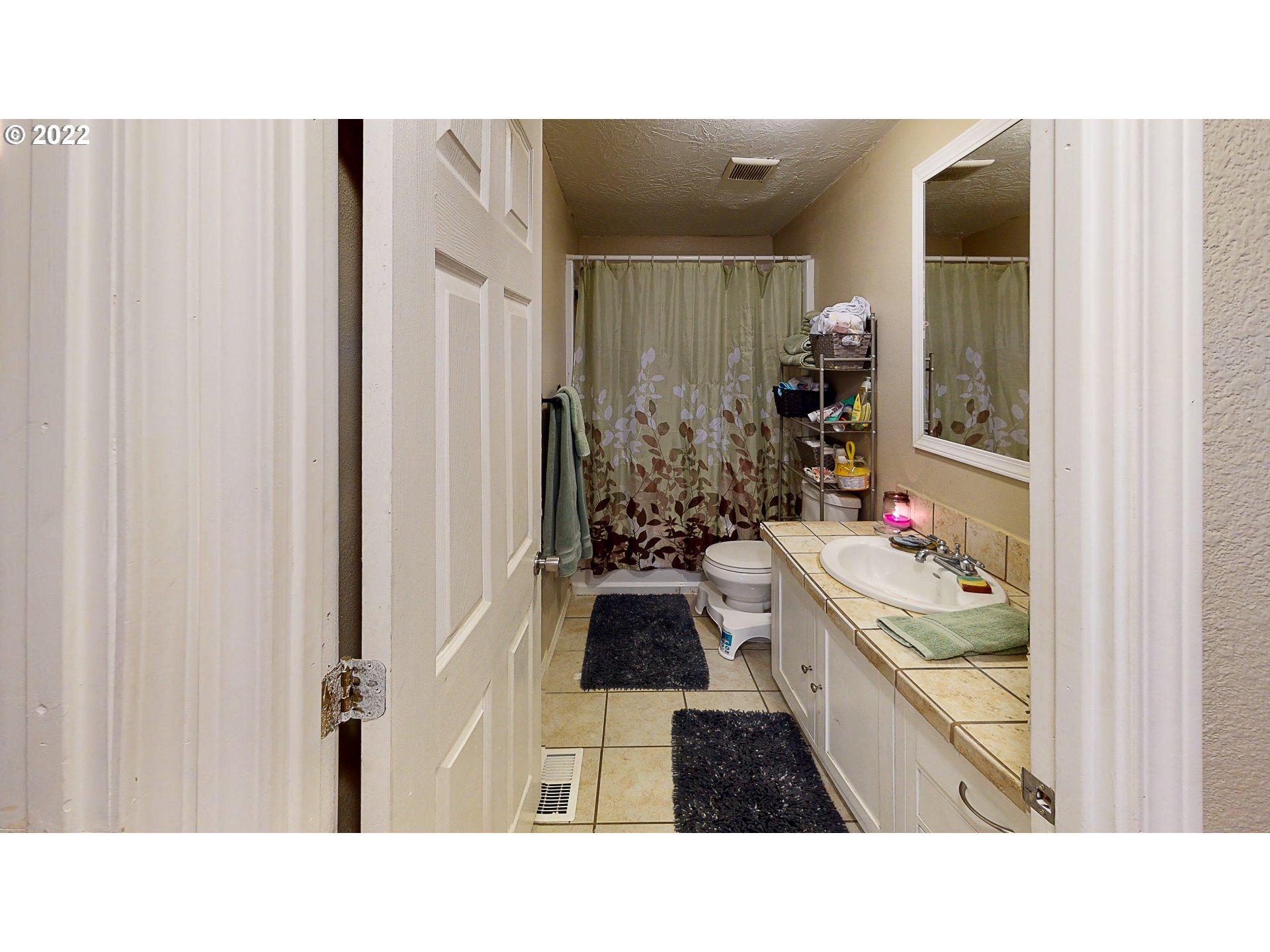 377 P G Sweet Road Kelso, WA 98626 - Photo 28 of 29 a bathroom with a sink and a large mirror