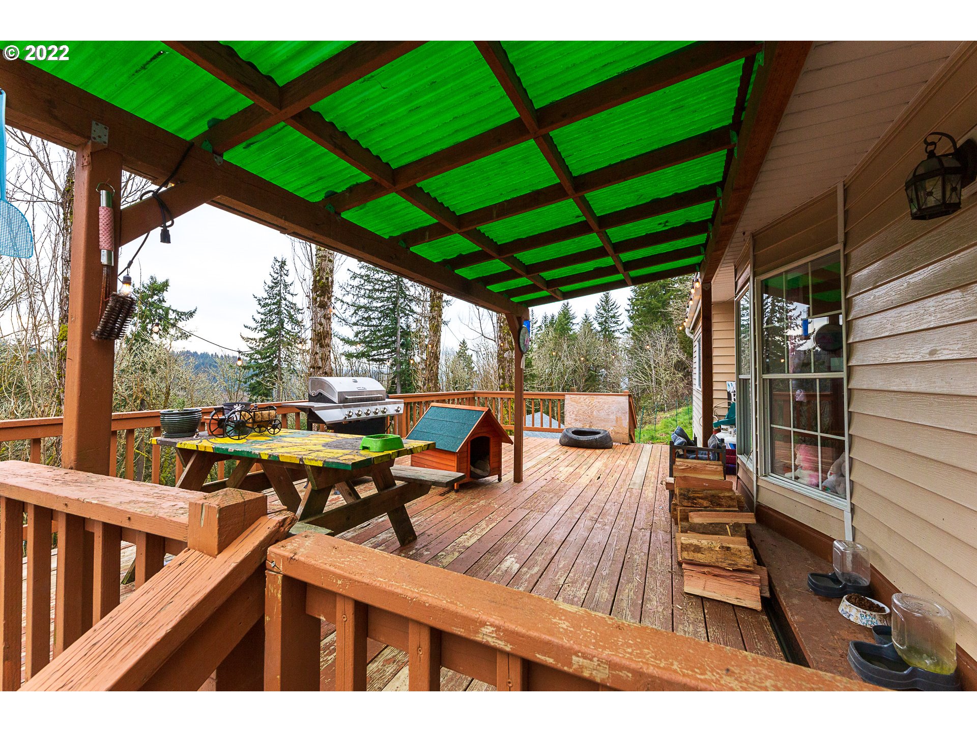 377 P G Sweet Road Kelso, WA 98626 - Photo 3 of 29 a view of a patio with table and chairs under an umbrella with a small yard