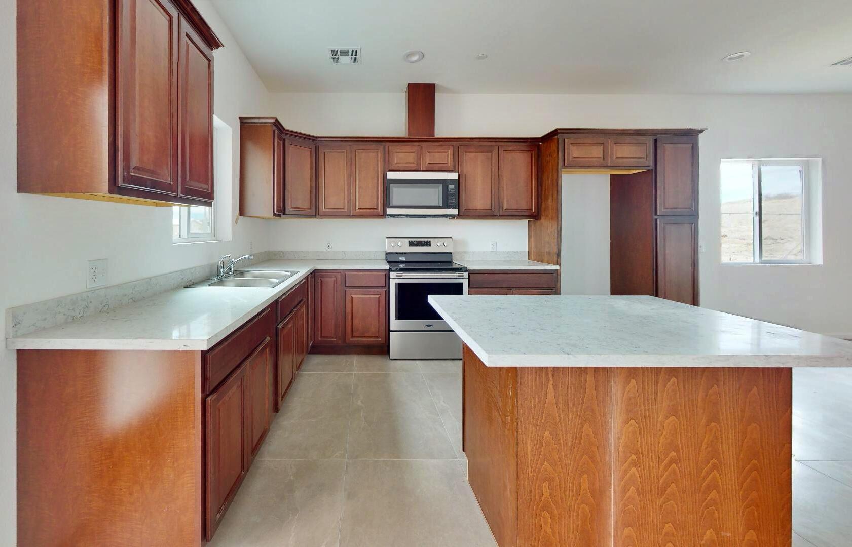 Undisclosed Address Mecca, CA 92254 - Photo 3 of 10 a kitchen with stainless steel appliances granite countertop a sink dishwasher stove top oven and cabinets with wooden floor