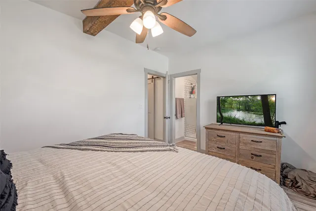 a bedroom with a bed and a flat screen tv