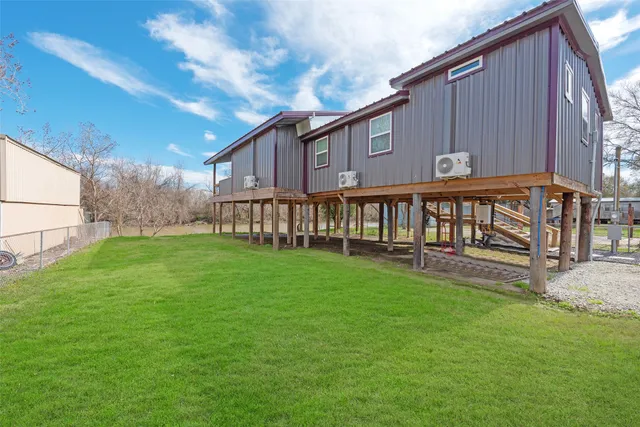 a view of a house with a yard and sitting area