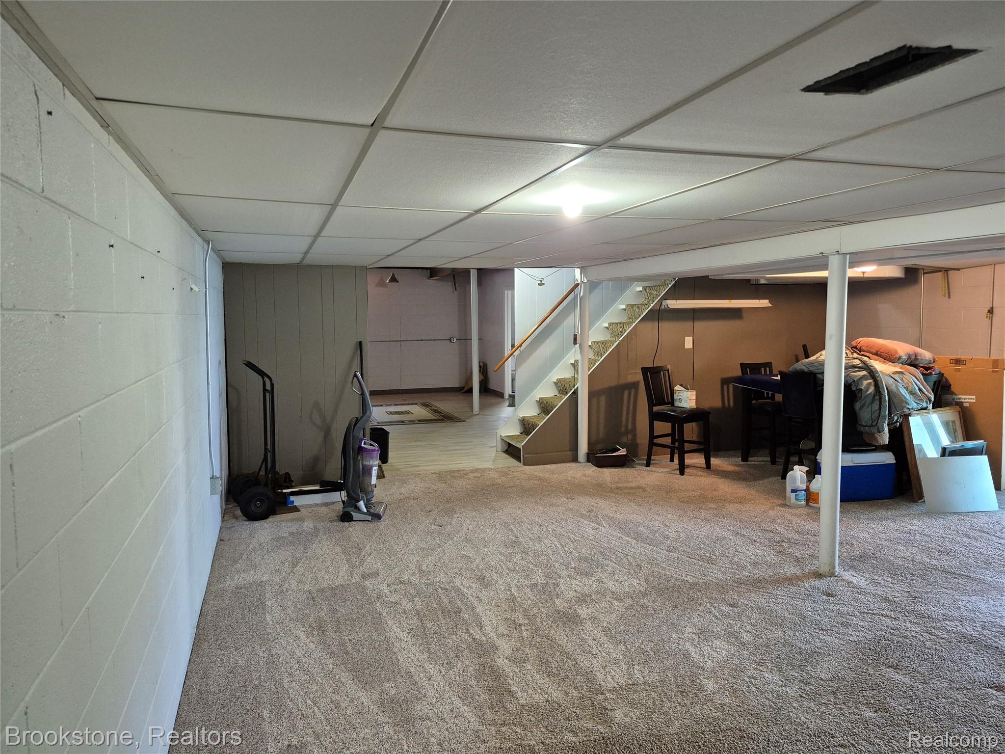 4295 Sashabaw Road Waterford, MI 48329 - Photo 31 of 37 Spacious lower level featuring light-toned carpeting and a drop ceiling with recessed lighting