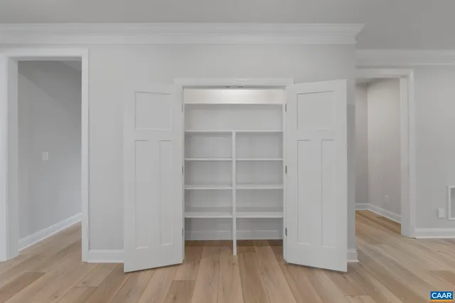 a view of walk in closet with empty racks