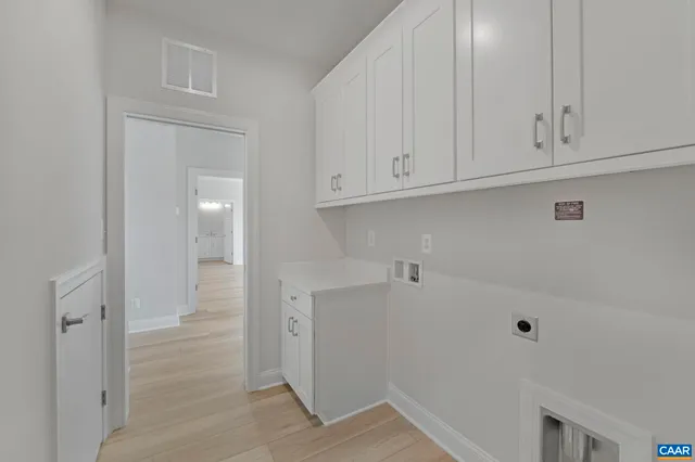 a view of cabinets and utility room with empty racks