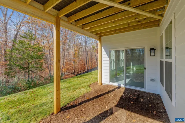 a bedroom with a bed and a large window with garden view