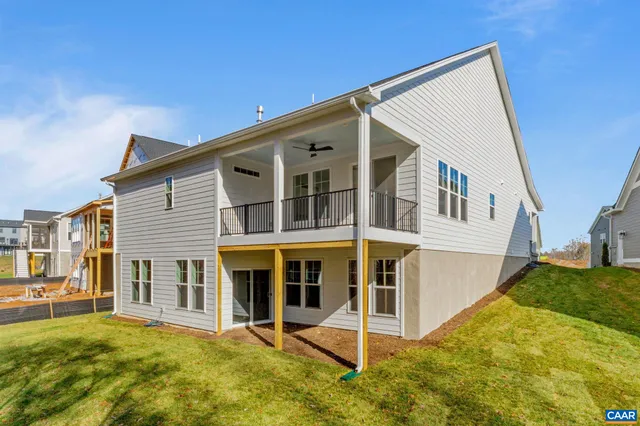 a view of a house with backyard and porch