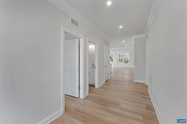 a view of hallway with wooden floor