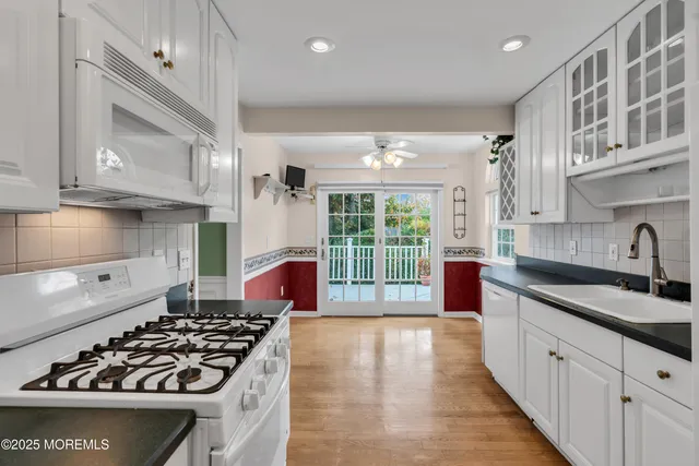a kitchen with stainless steel appliances a sink stove and cabinets