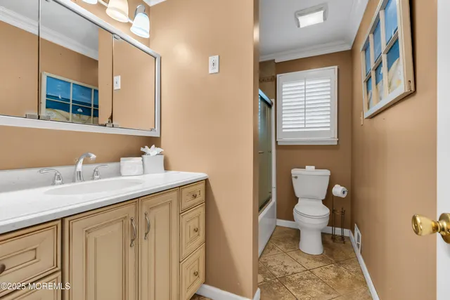 a bathroom with a granite countertop sink a toilet and a mirror