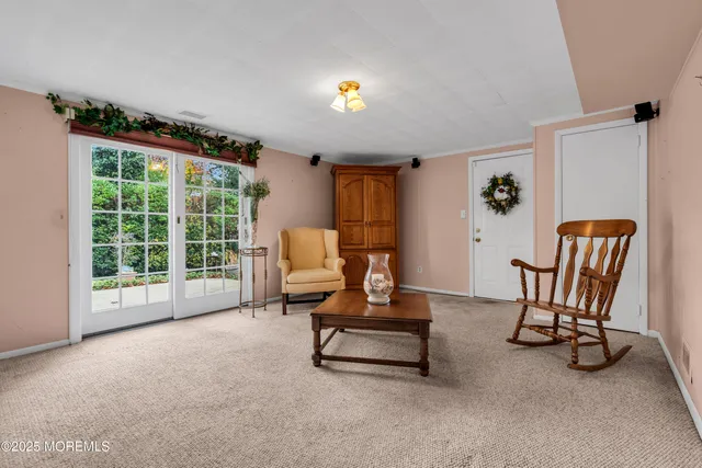 a living room with furniture and a floor to ceiling window