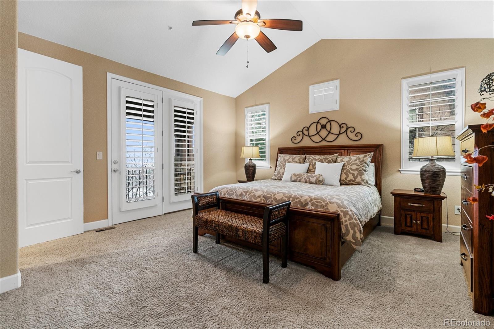 4315 Chateau Ridge Road Castle Rock, CO 80108 - Photo 15 of 26 a bedroom with a large bed and a chandelier