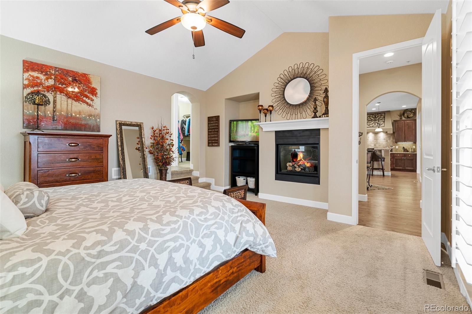 4315 Chateau Ridge Road Castle Rock, CO 80108 - Photo 16 of 26 a bedroom with a bed and a fireplace