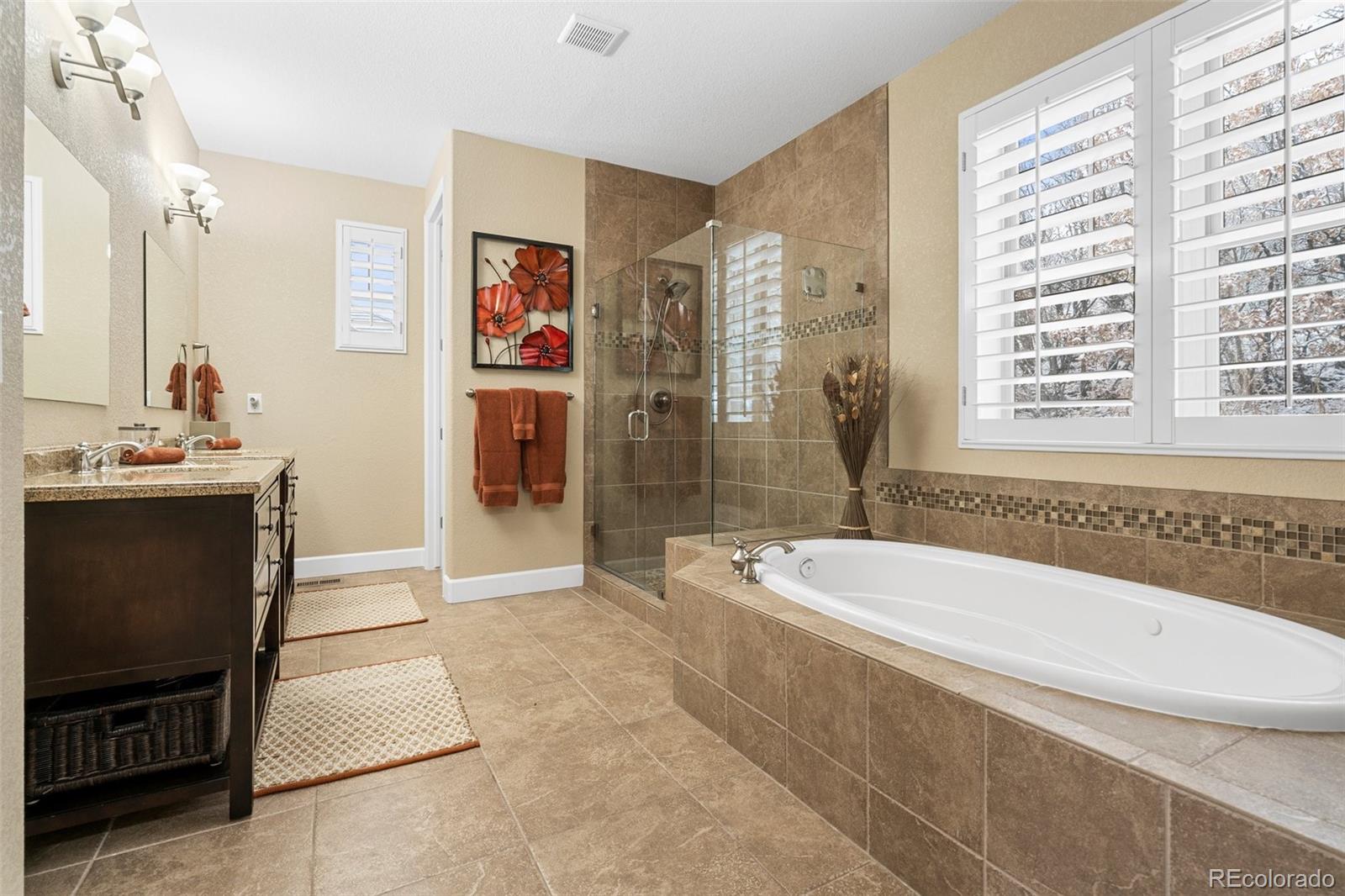 4315 Chateau Ridge Road Castle Rock, CO 80108 - Photo 17 of 26 a bathroom with a tub a sink and a shower