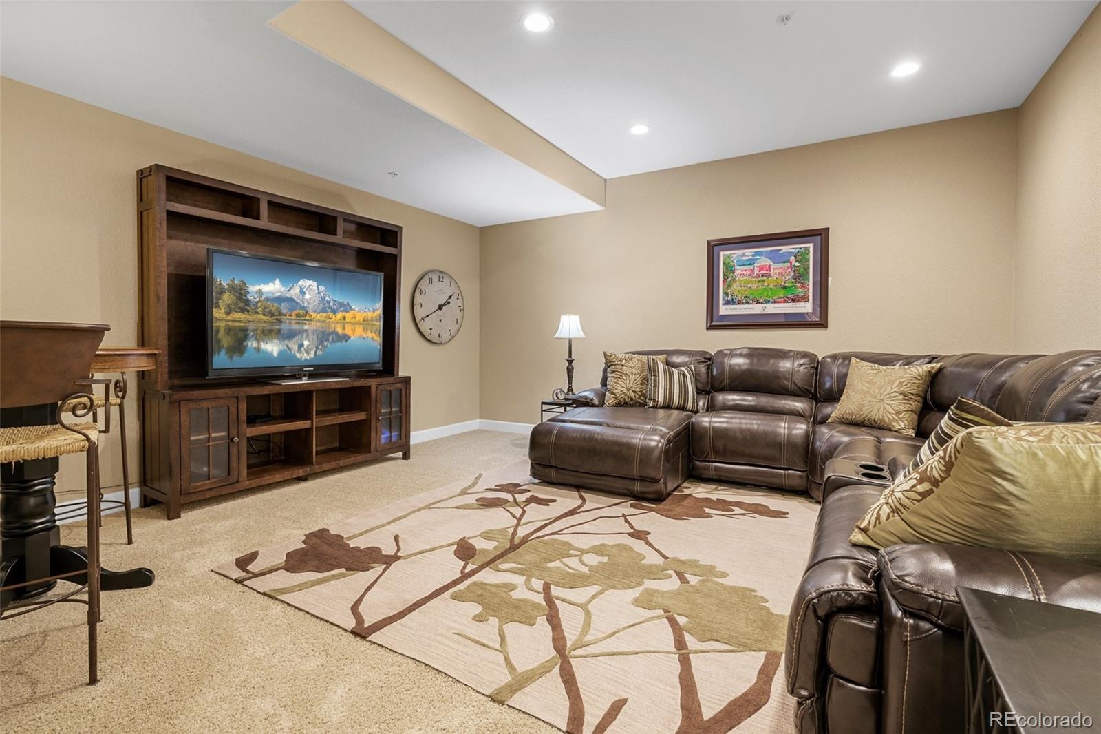 4315 Chateau Ridge Road Castle Rock, CO 80108 - Photo 20 of 26 a living room with furniture and a flat screen tv