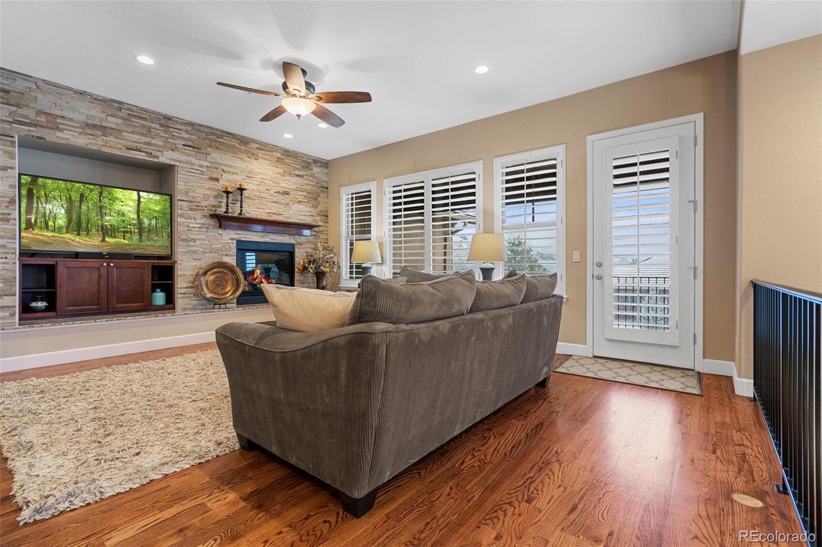 4315 Chateau Ridge Road Castle Rock, CO 80108 - Photo 4 of 26 a living room with furniture and a flat screen tv