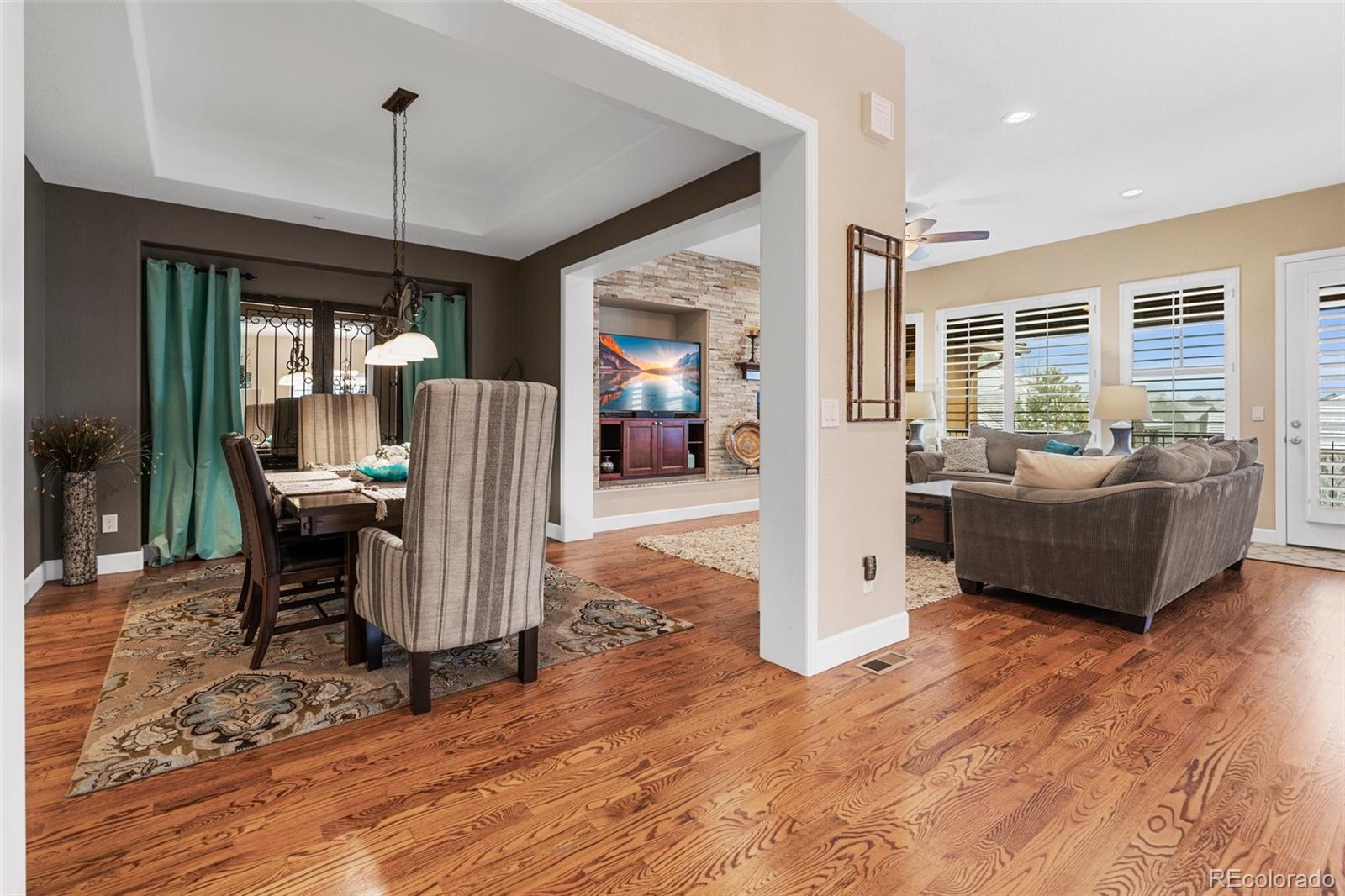 4315 Chateau Ridge Road Castle Rock, CO 80108 - Photo 7 of 26 a dining room with furniture a chandelier and wooden floor