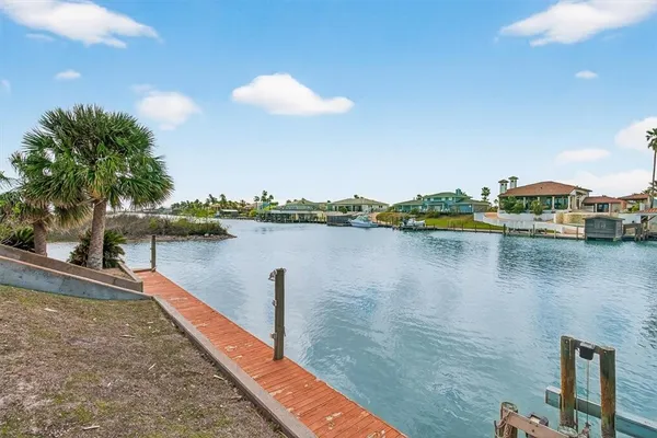 a view of a lake with houses in the background