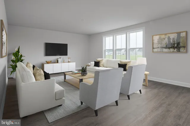 a living room with furniture a flat screen tv and a large window