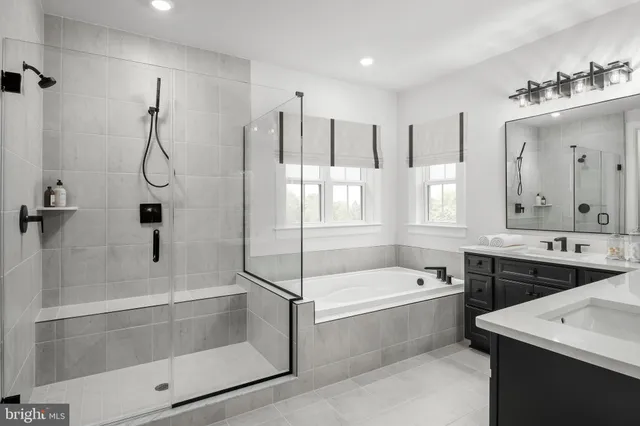 a bathroom with a tub sink and mirror